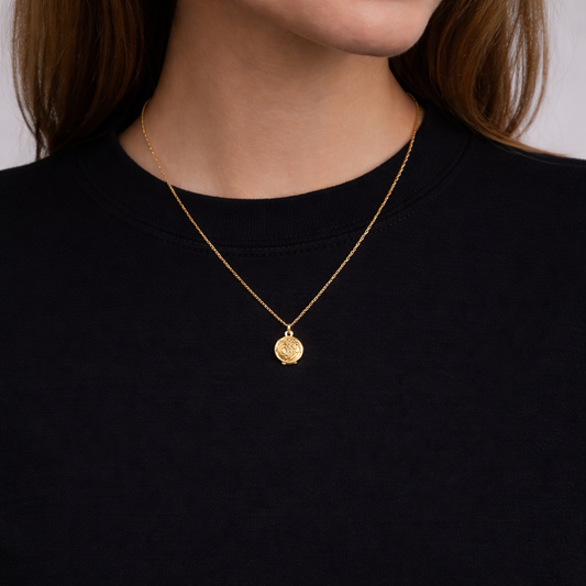 Vintage 1990s Locket, styled on a model with a black top. 