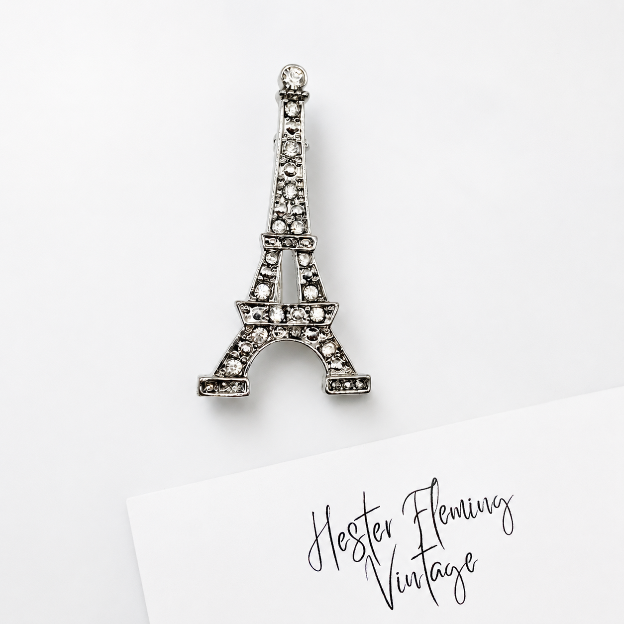 Vintage 90s Eiffel Tower Brooch on white background. 