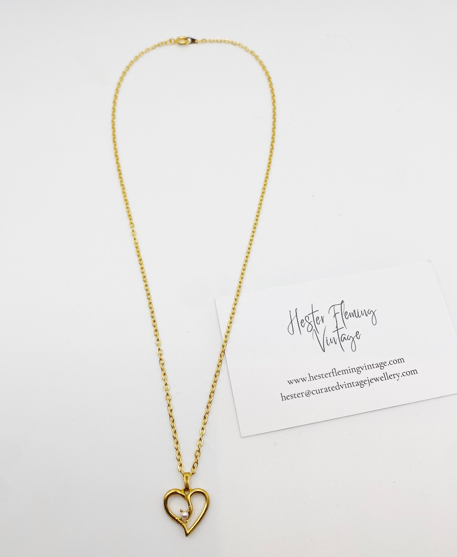 Sentimental vintage charm necklace with faux pearl detail. 