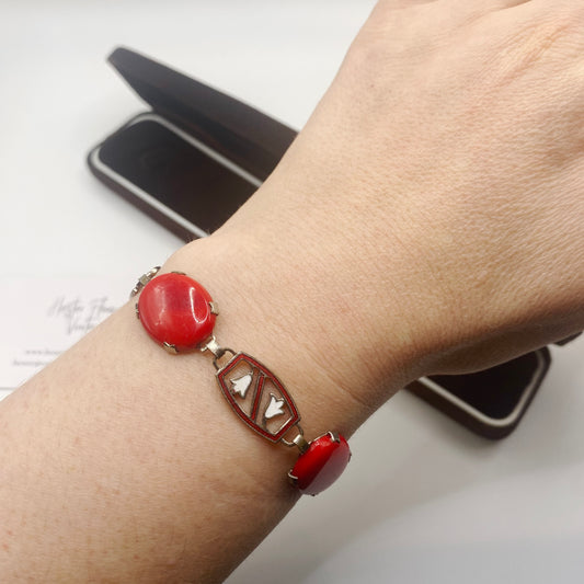 Collectible Czech red glass bracelet with enamel accents, 1940s vintage jewellery, on model. 
