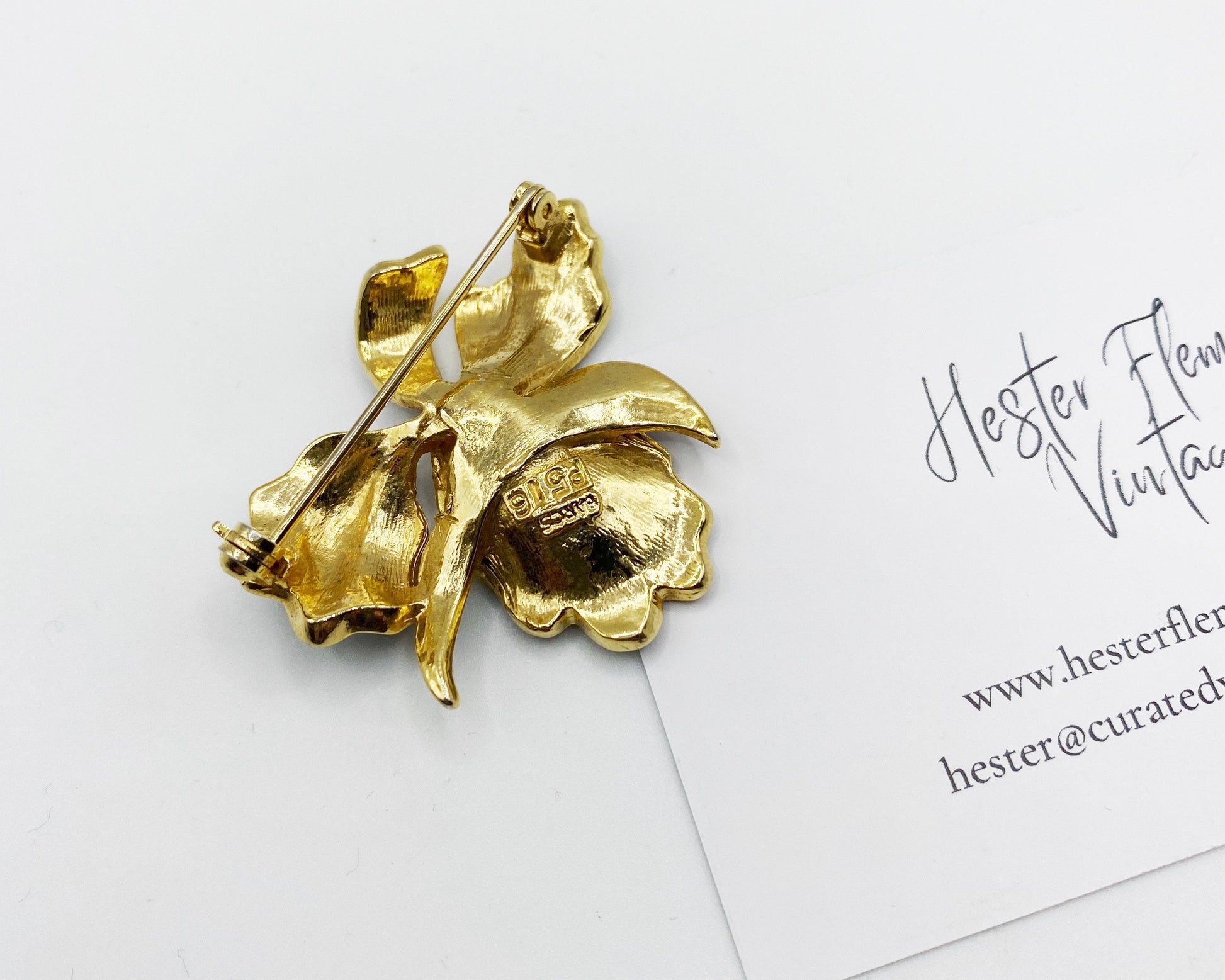 Back of vintage 1980s BARCS iris brooch in black enamel and gold plating