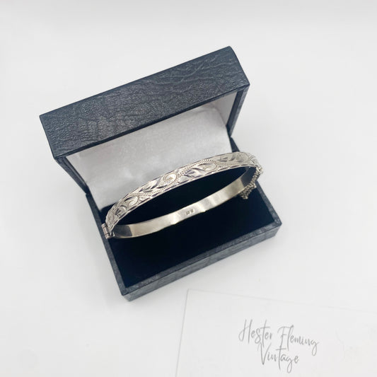 Vintage Birmingham sterling silver hinged bangle with engraved leaf and bright-cut detailing