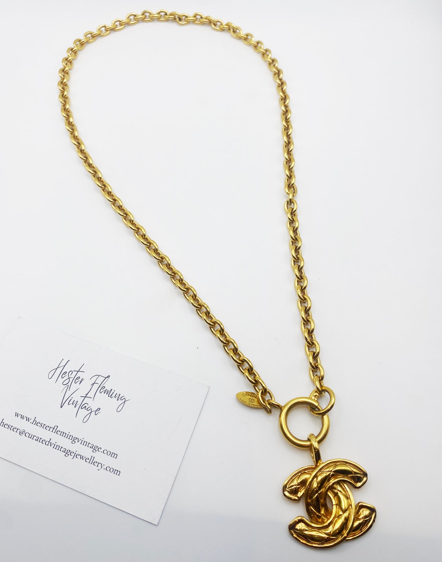 Authentic 1980s Chanel logo pendant necklace in gold tone, vintage designer jewellery.