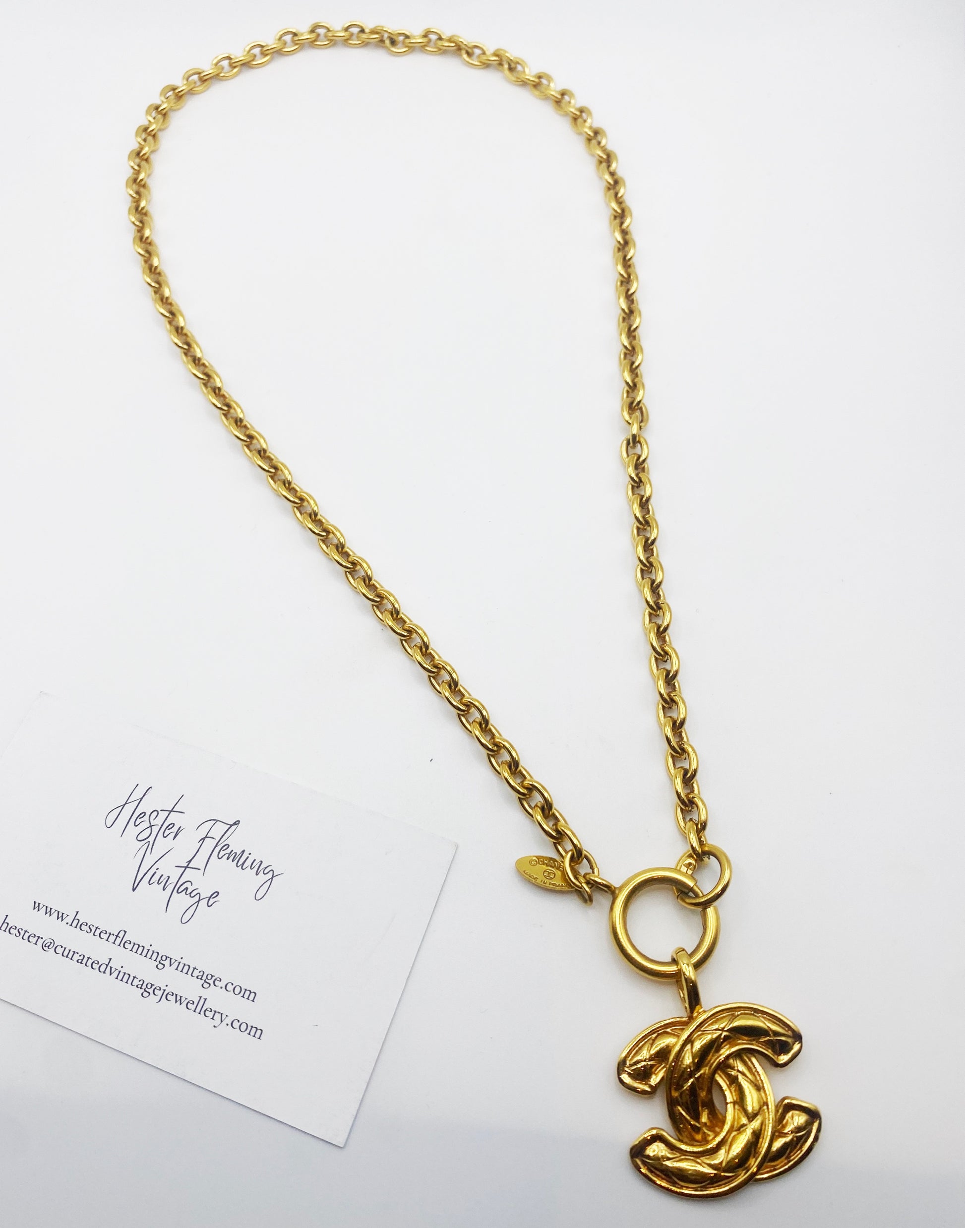 Authentic 1980s Chanel logo pendant necklace in gold tone, vintage designer jewellery.