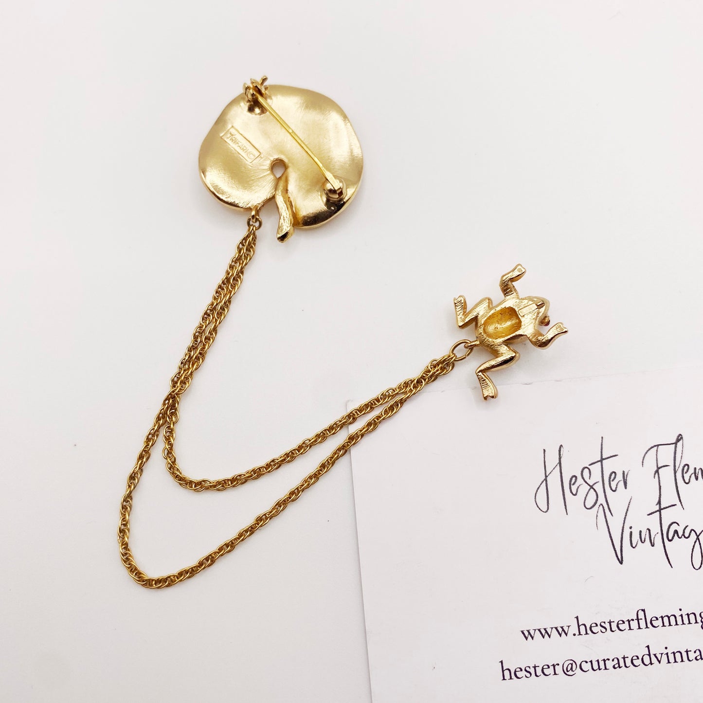 Back view of collectible vintage Trifari frog brooch with signed hallmark.