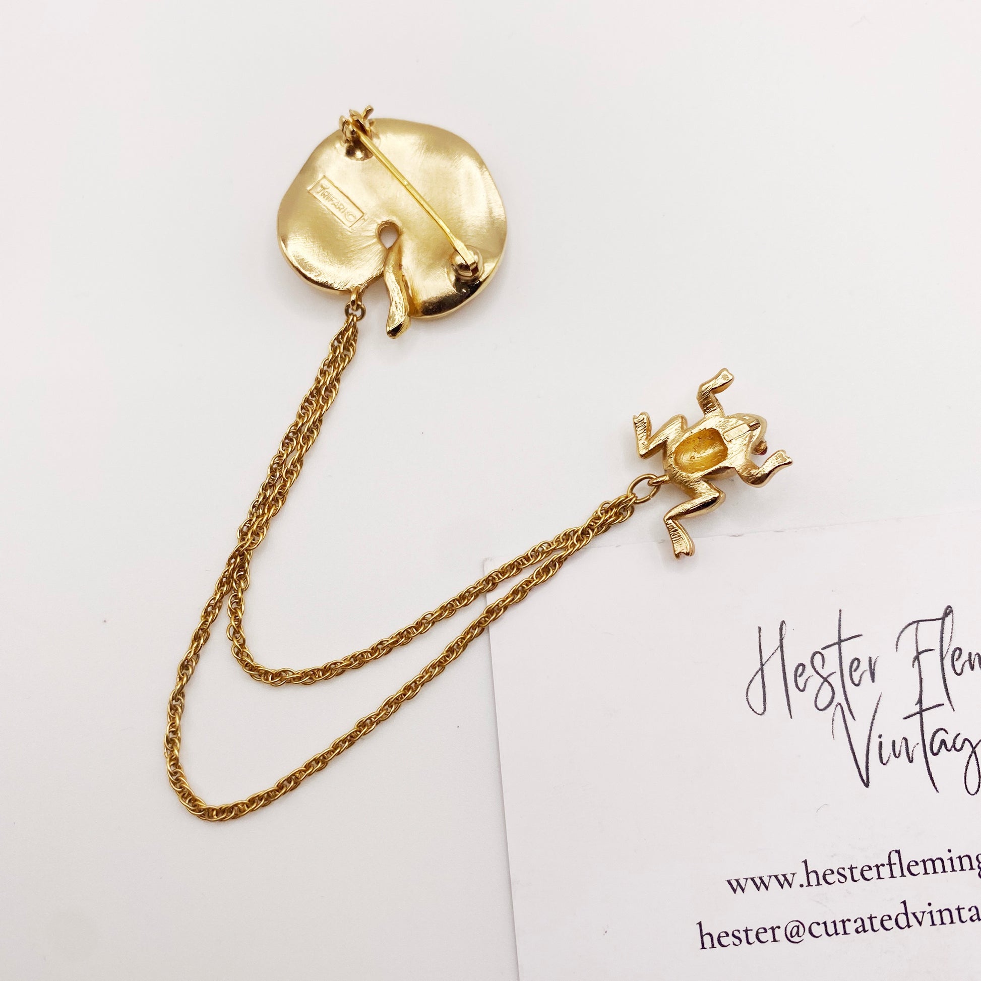 Back view of collectible vintage Trifari frog brooch with signed hallmark.
