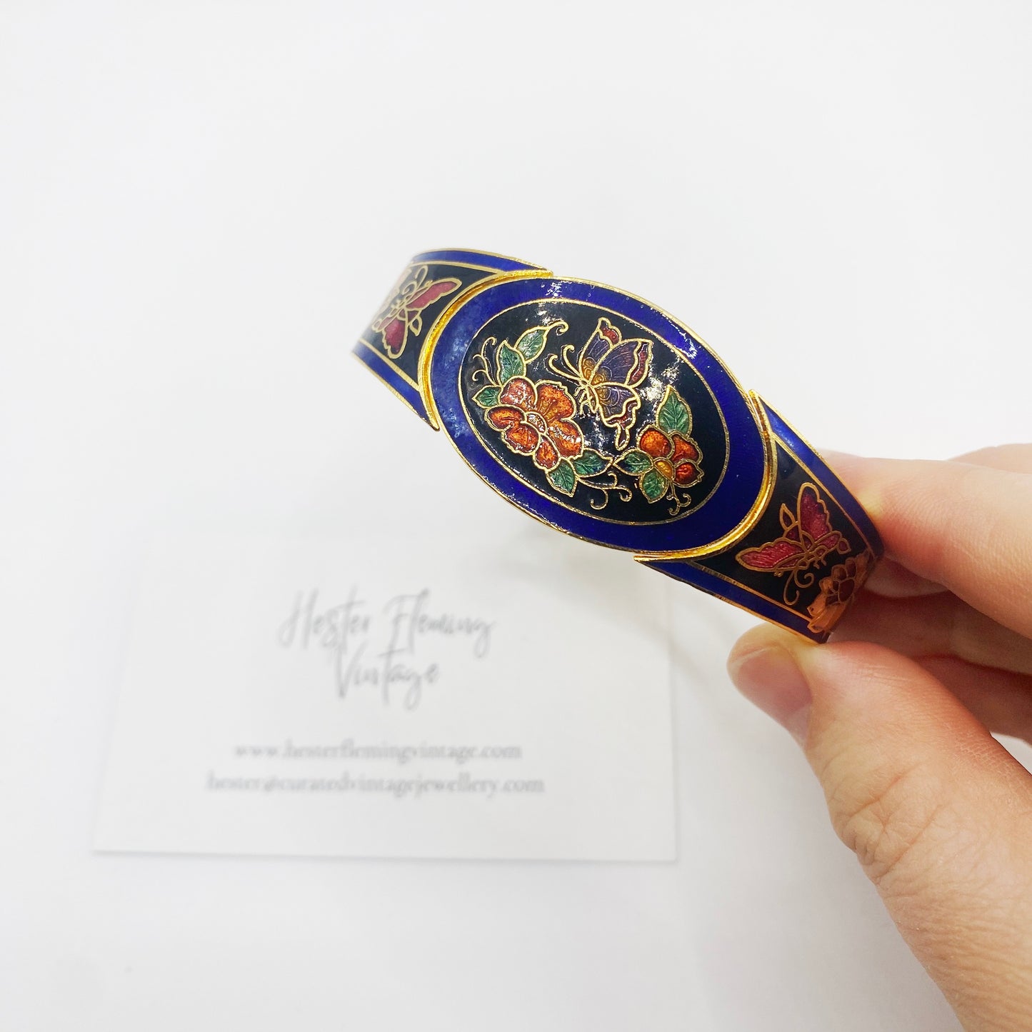 Close-up of butterfly and floral enamel detail on 1980s cloisonné bangle with 22kt gold-plated edges.
