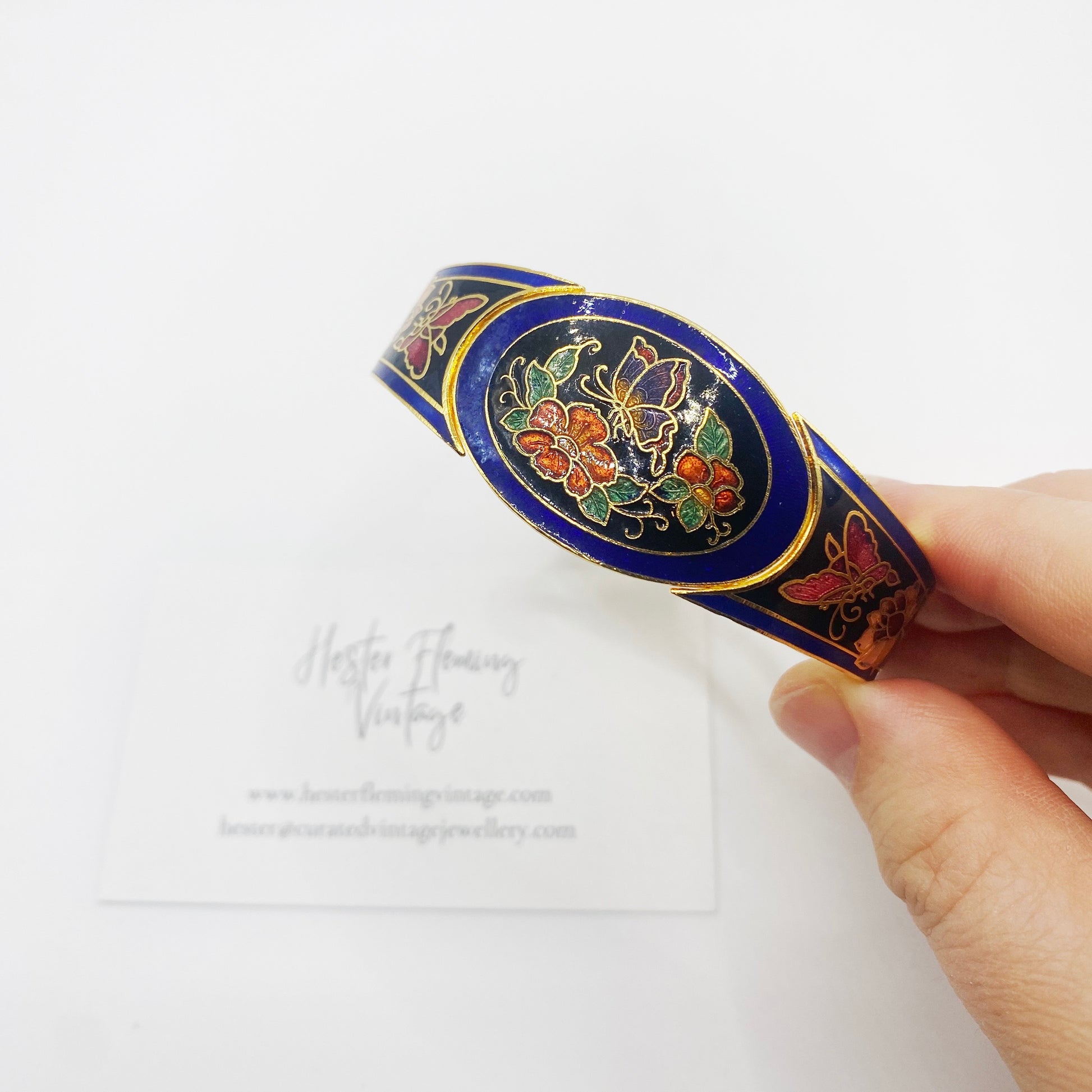 Close-up of butterfly and floral enamel detail on 1980s cloisonné bangle with 22kt gold-plated edges.