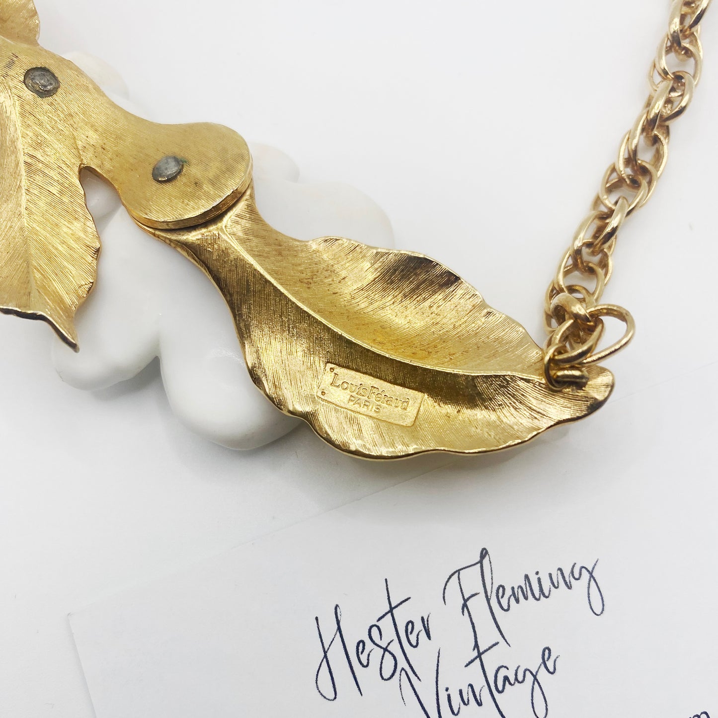 Close-up of 1984 Luis Feraud necklace signature.