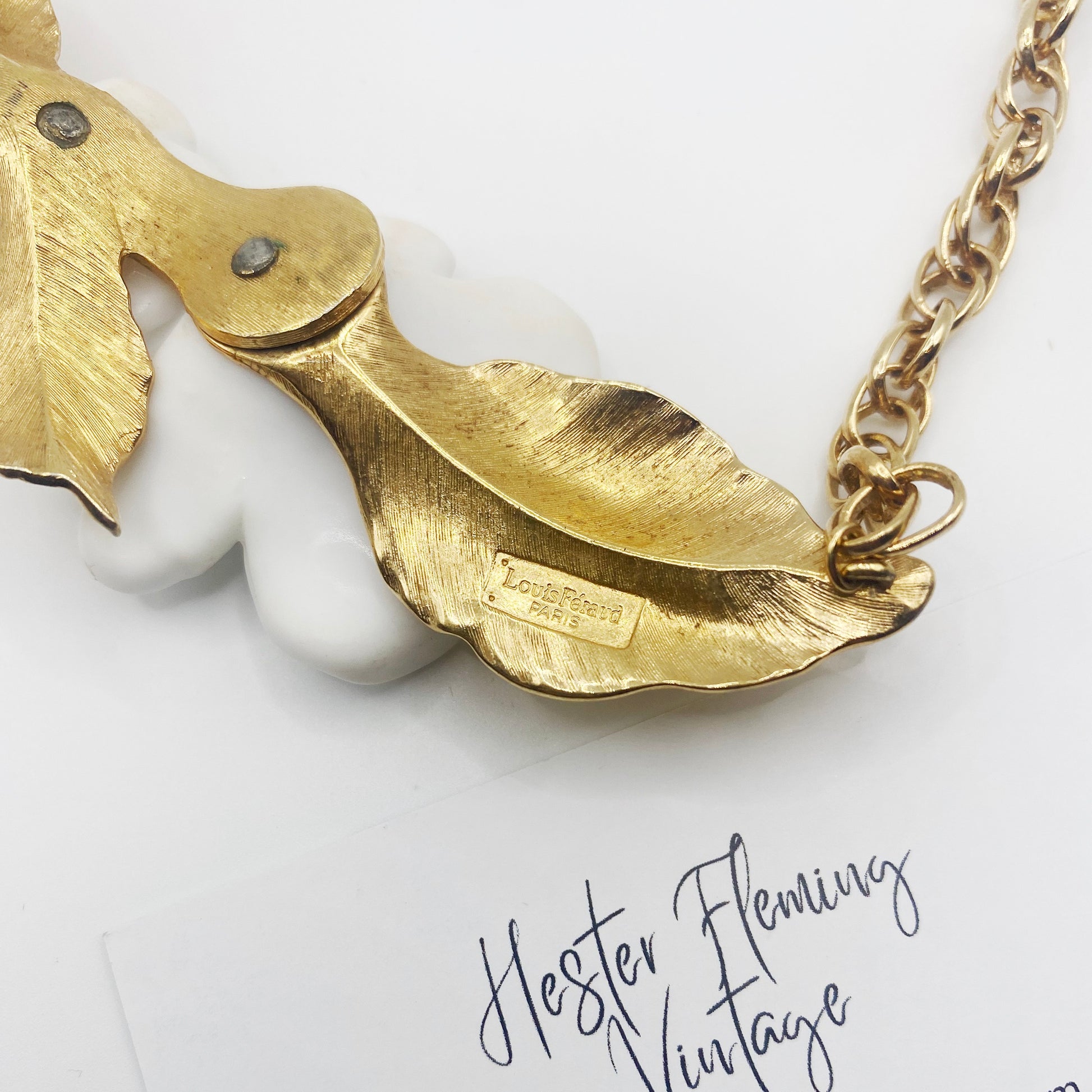 Close-up of 1984 Luis Feraud necklace signature.