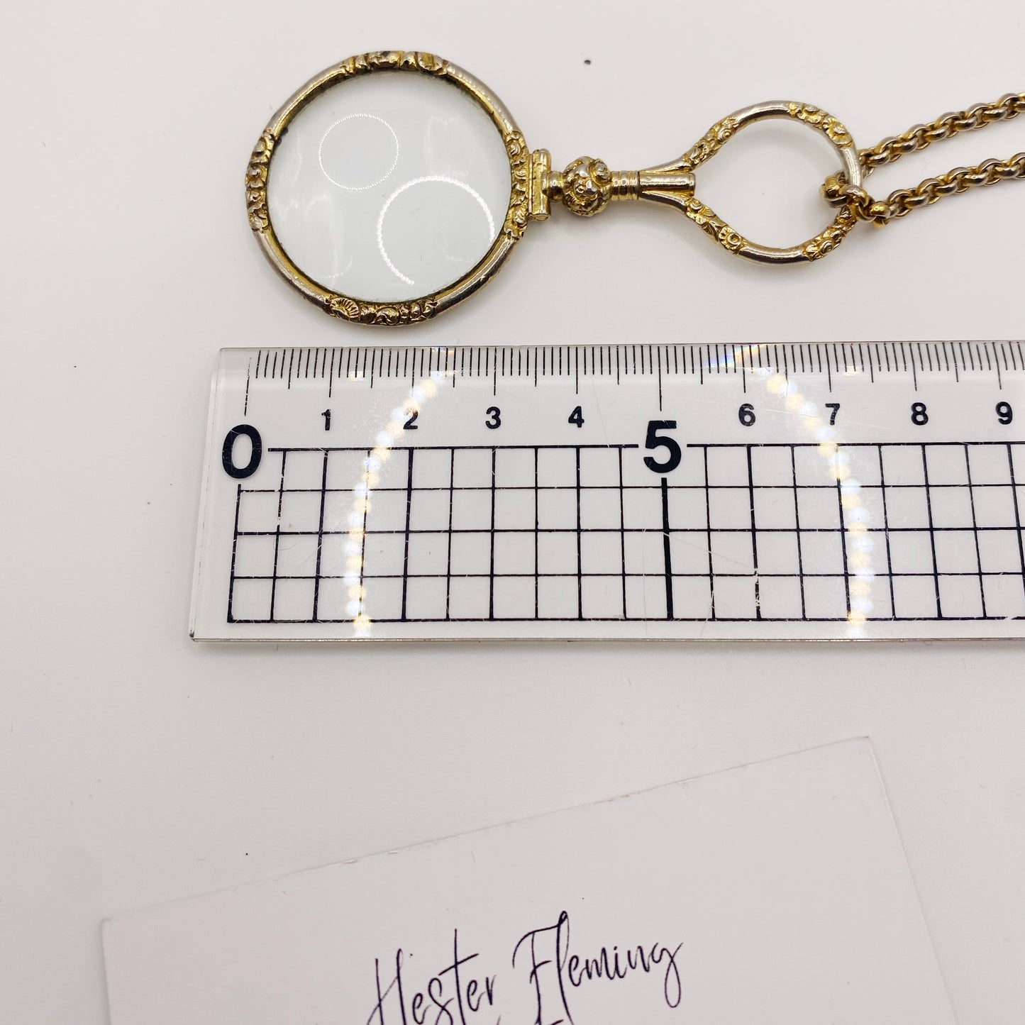 Measurement of gold-plated Quizzer pendant.