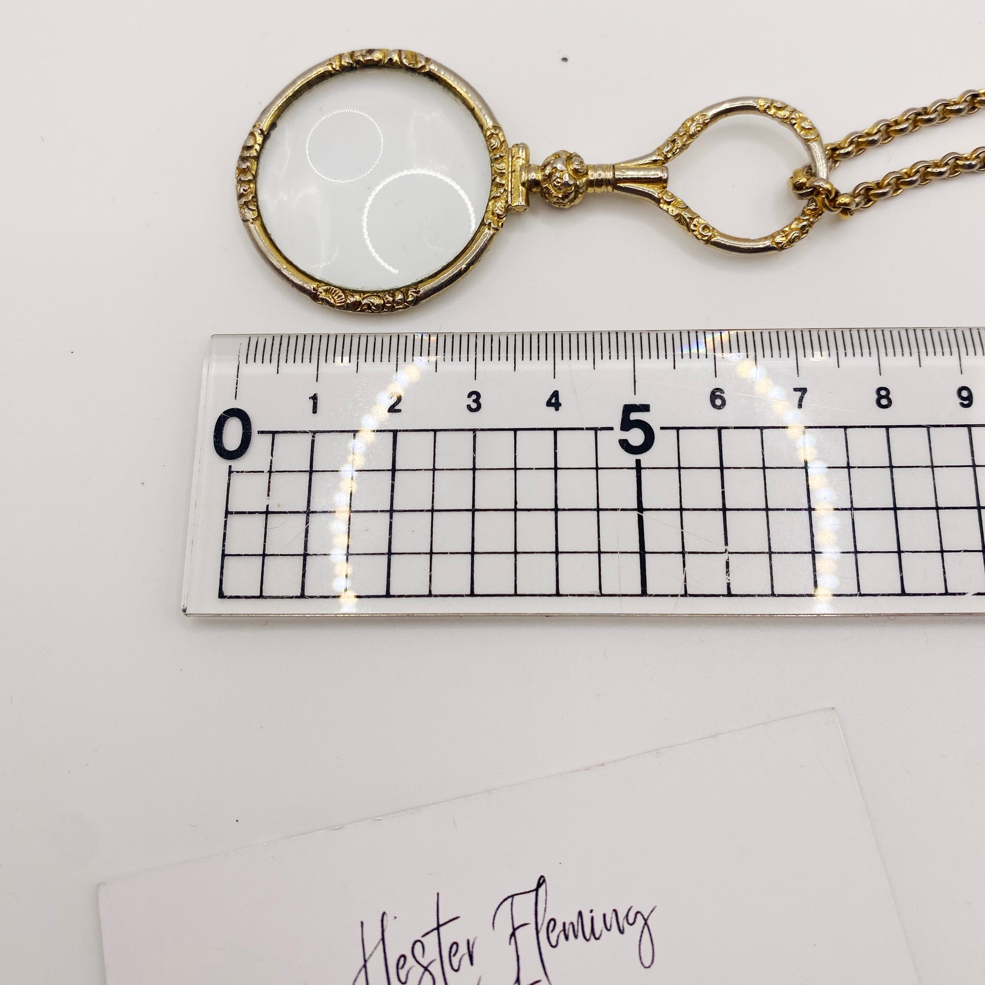 Measurement of gold-plated Quizzer pendant.