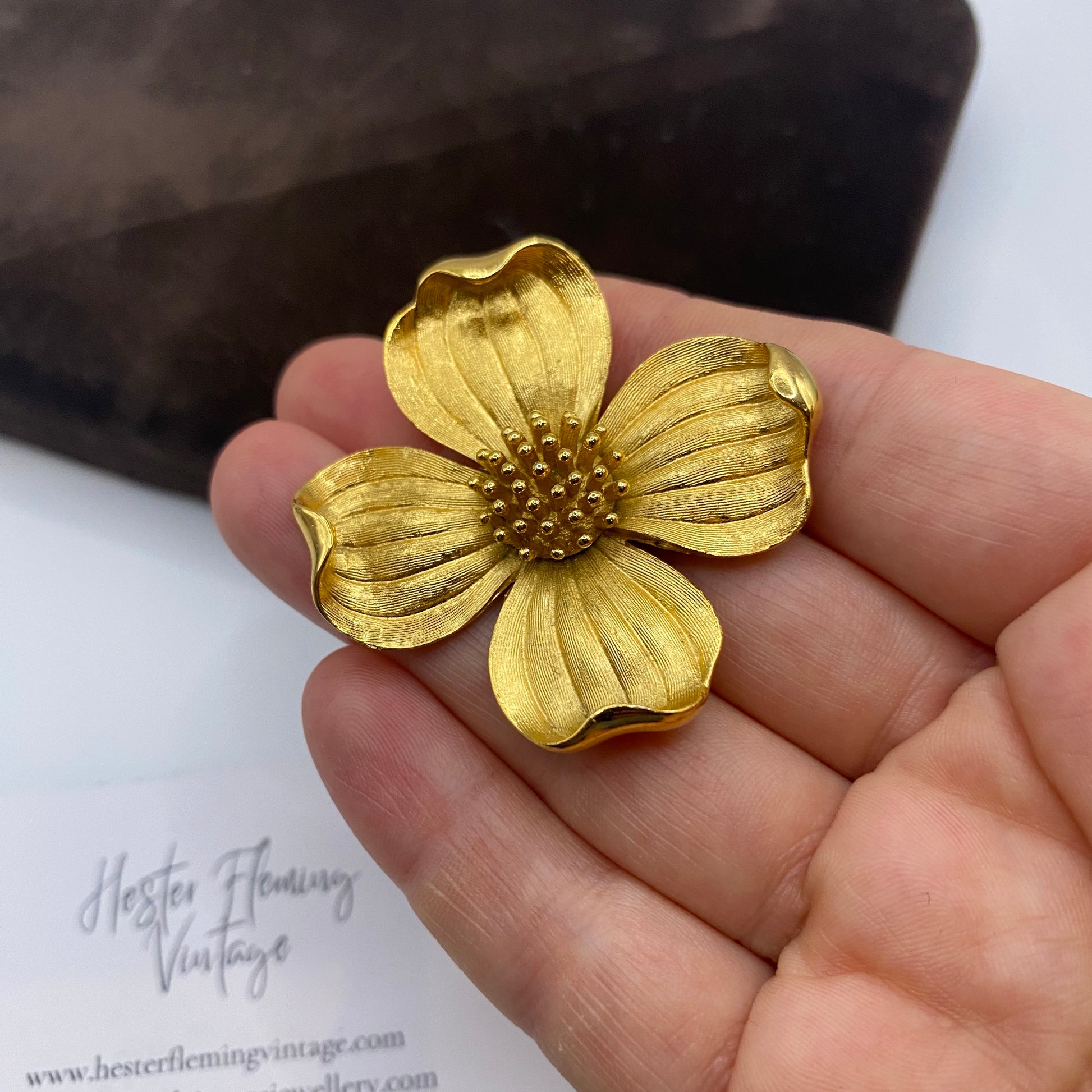 Close-up of mid-century Trifari Dogwood floral pin showing textured petals