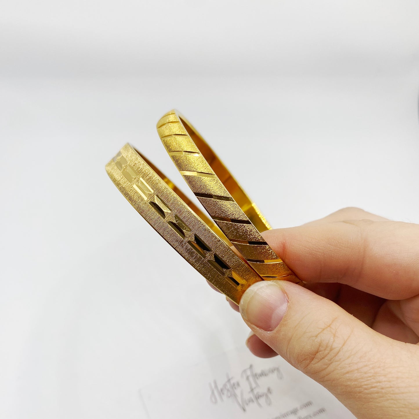 Layered view of Monet Splendor Collection gold bangles, authentic vintage jewellery.