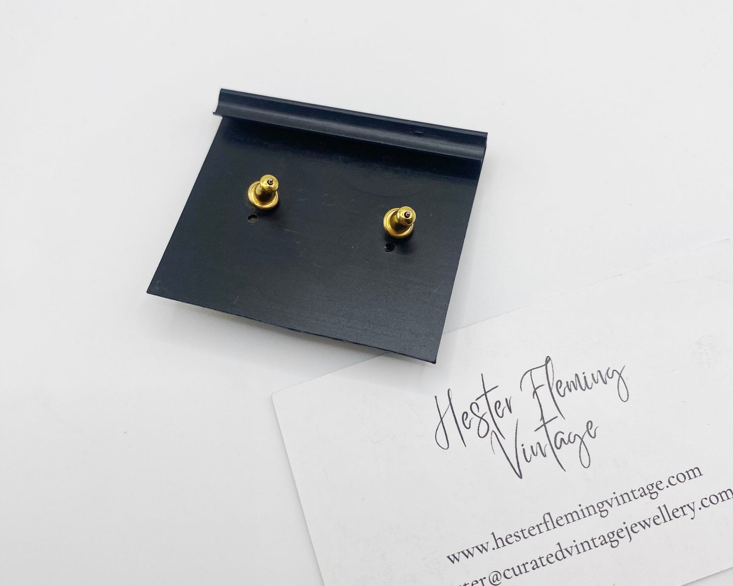 Back view of 1990s Monet signed gold-tone rhinestone earrings showing post closures