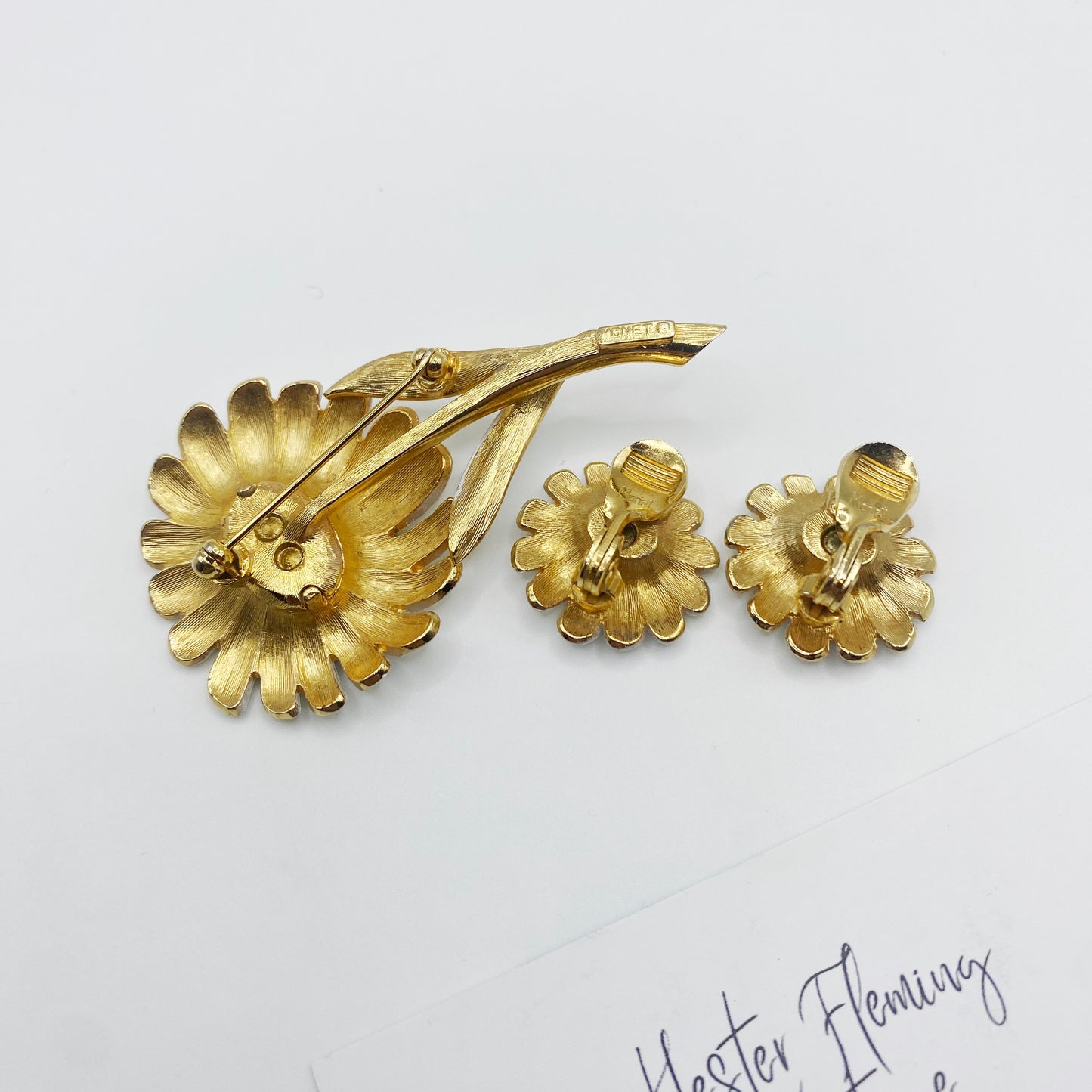 1960s Monet white enamel brooch and earring set, back view. Signed, Monet. Clip on fitting for earrings.