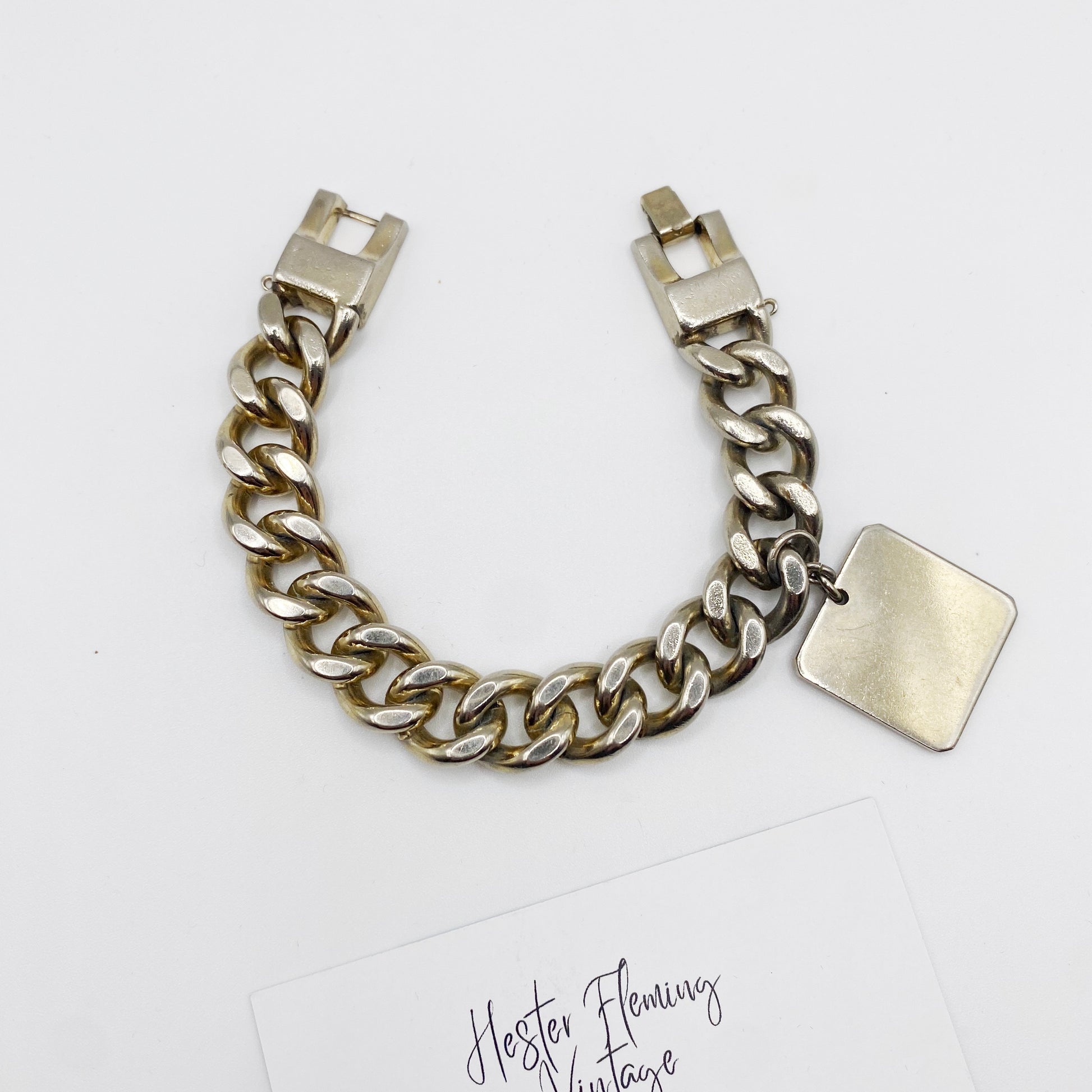 Flatlay of 1940s retro silver chain bracelet.