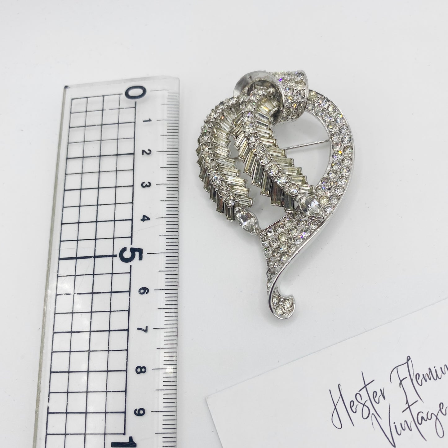 Vintage Pennino rhinestone brooch shown with ruler for scale