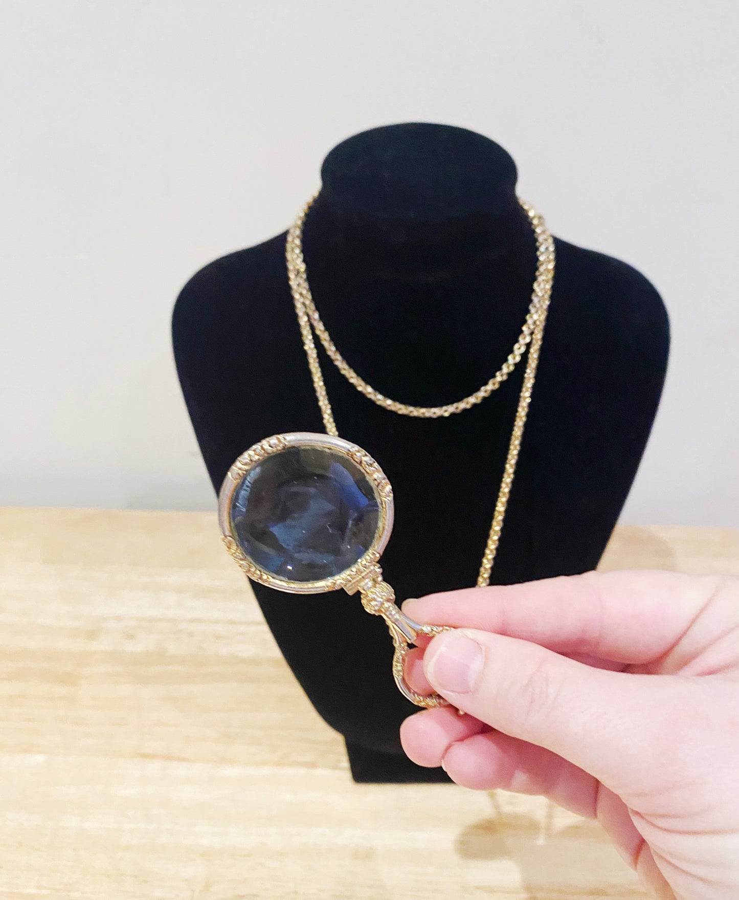 Close-up of gold-plated Quizzer pendant with double swivel clasp