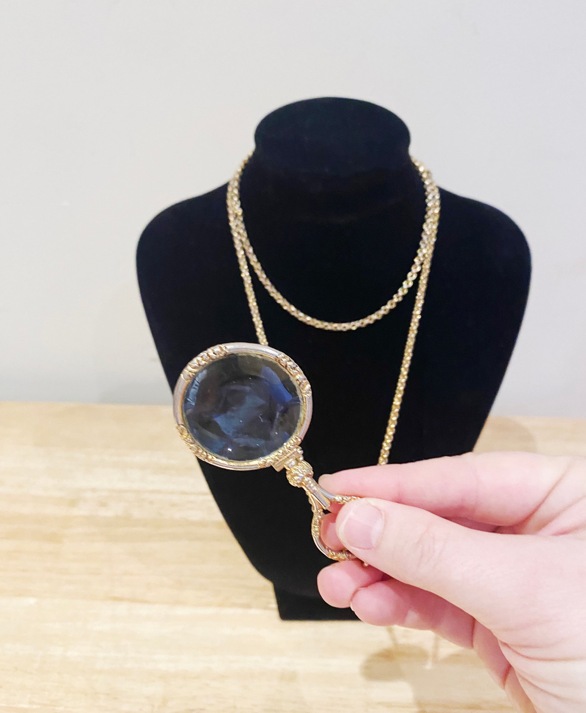 Close-up of gold-plated Quizzer pendant with double swivel clasp