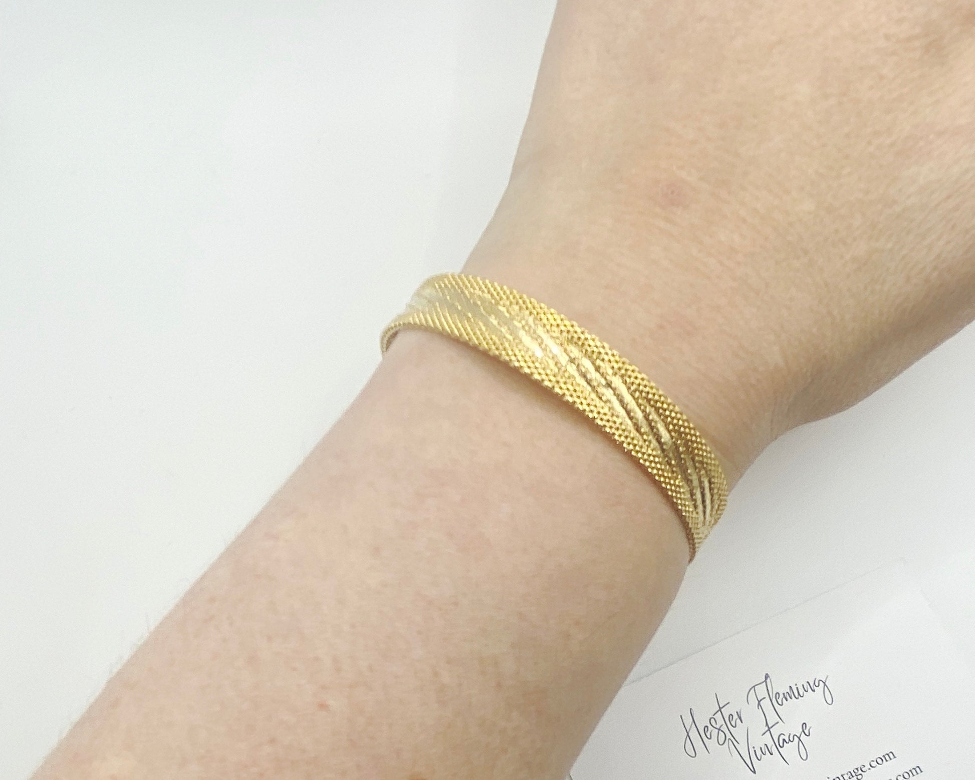 Retro 1970s gold-plated mesh bracelet styled on wrist, classic vintage jewellery look