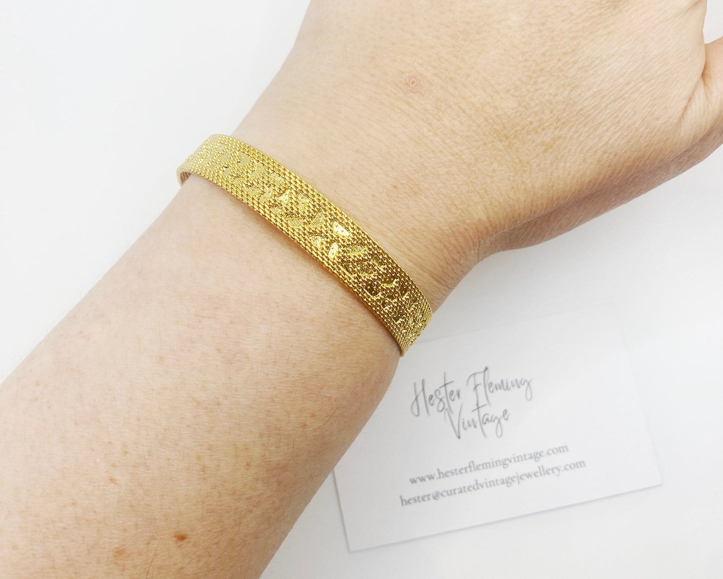 1970s retro gold-plated bracelet styled on wrist, classic vintage jewellery look