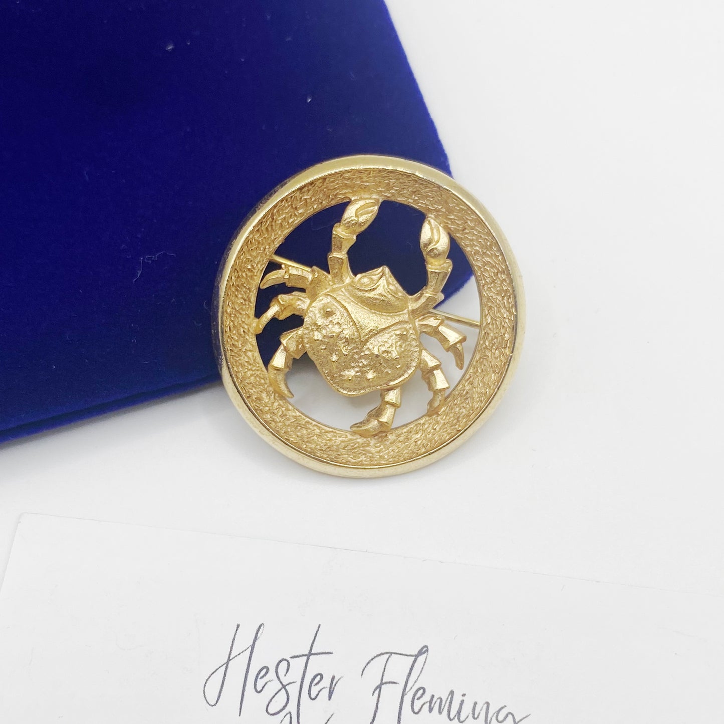 1970s Trifari Cancer zodiac brooch in gold tone featuring sculpted crab within circular textured frame