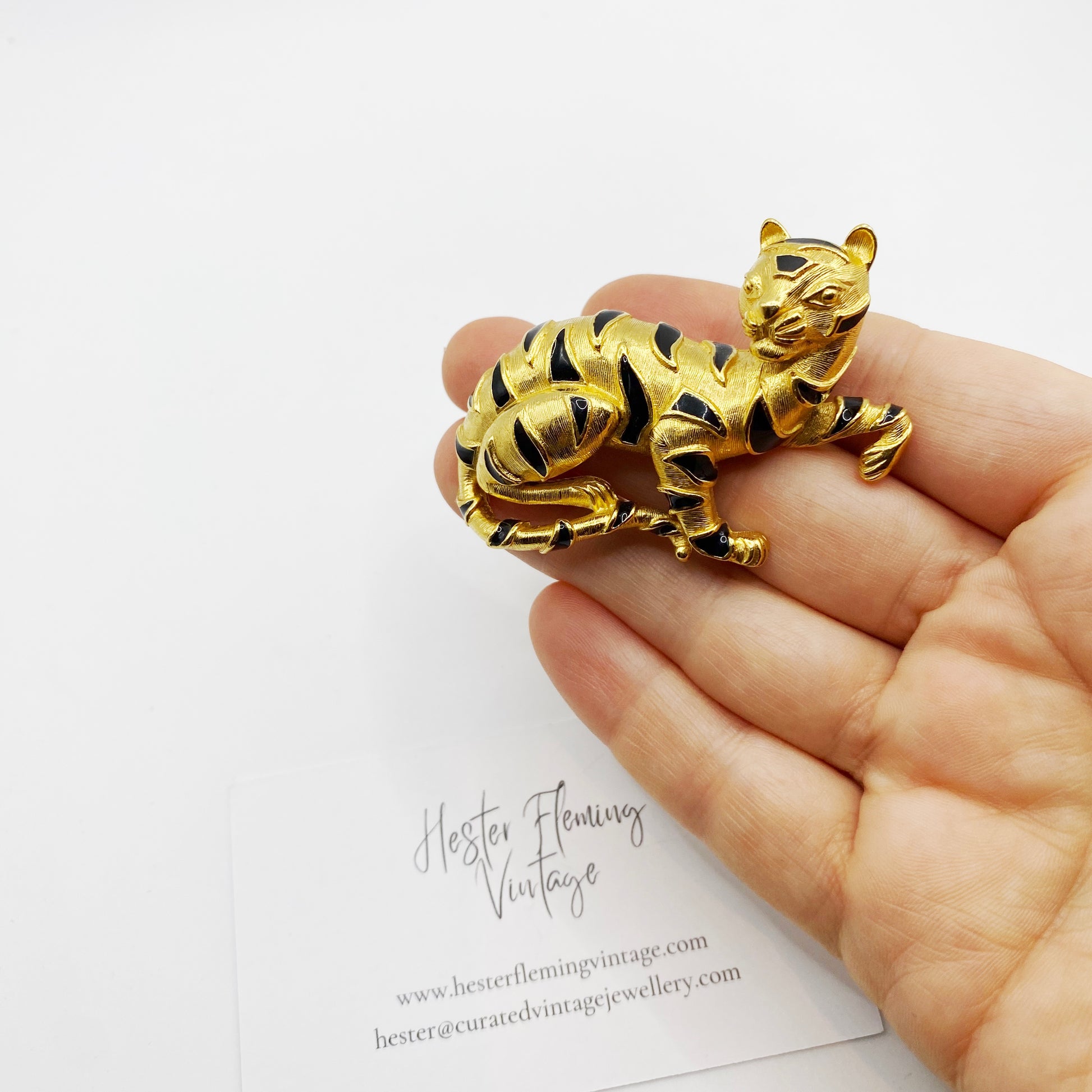 Vintage Trifari tiger brooch shown in hand for scale