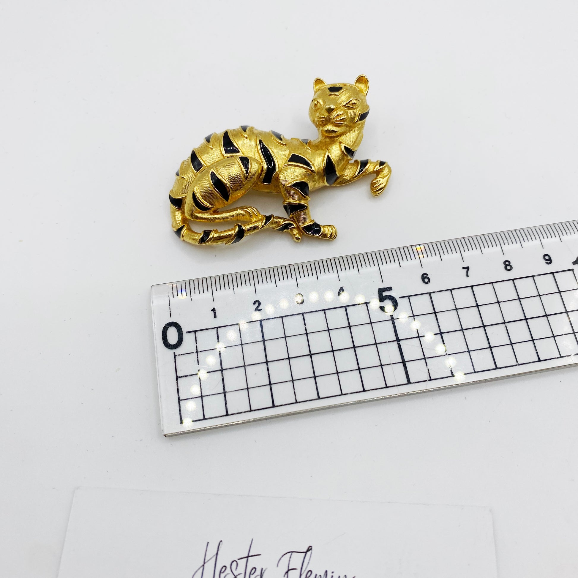 Vintage Trifari tiger brooch next to ruler showing size