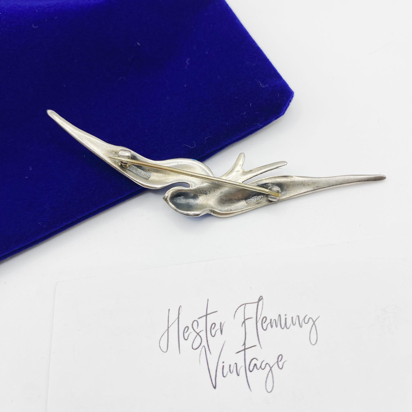 Back of Victorian sterling silver enamel swallow brooch showing antique pin clasp