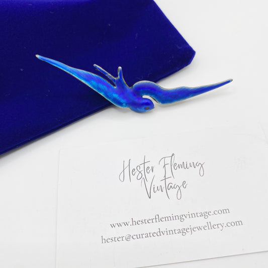 Victorian sterling silver swallow brooch with luminous blue enamel wings, front view