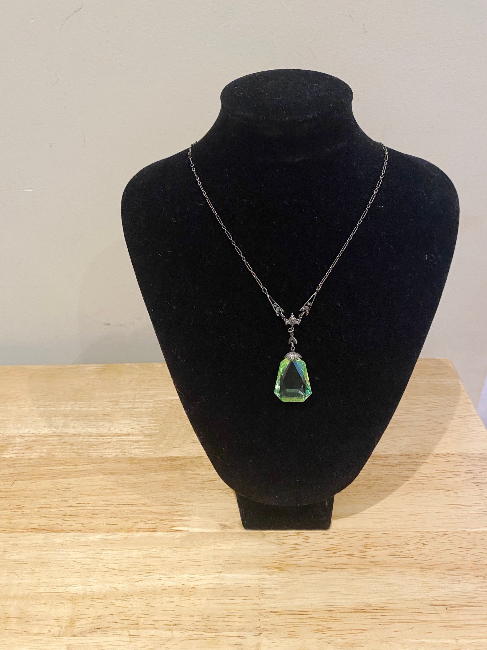 Front view of vintage 1930s uranium glass and marcasite necklace on black metal chain
