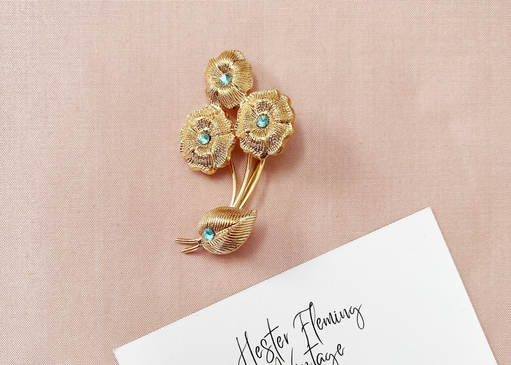 Vintage 1940s French floral brooch in gold tone with aquamarine crystal