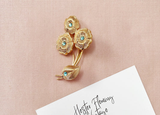 Vintage 1940s French floral brooch in gold tone with aquamarine crystal