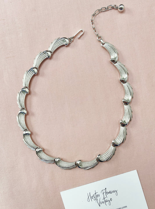 Front view of vintage 1950s Crown Trifari silver leaf necklace in textured silvertone metal.