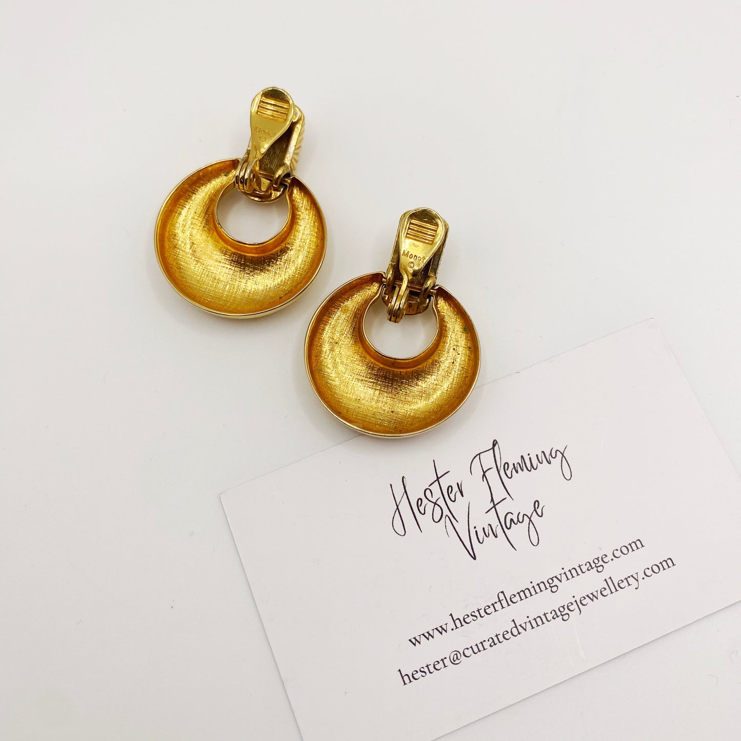 Back view showing signed Monet hallmark on vintage doorknocker earring