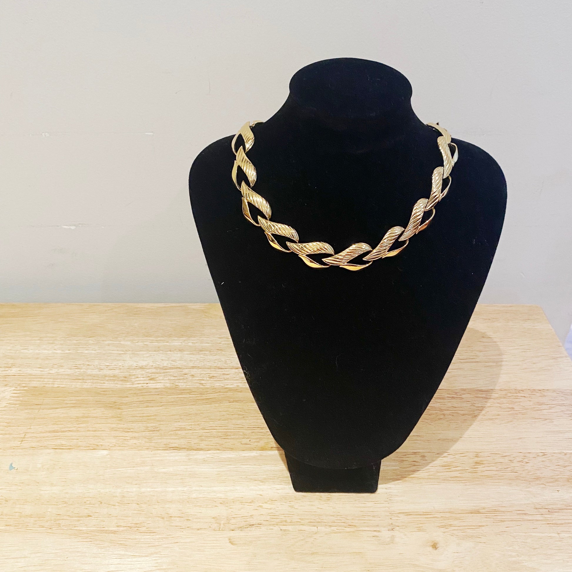 The Trifari heart necklace worn to show length, scale, and how it drapes as a statement piece