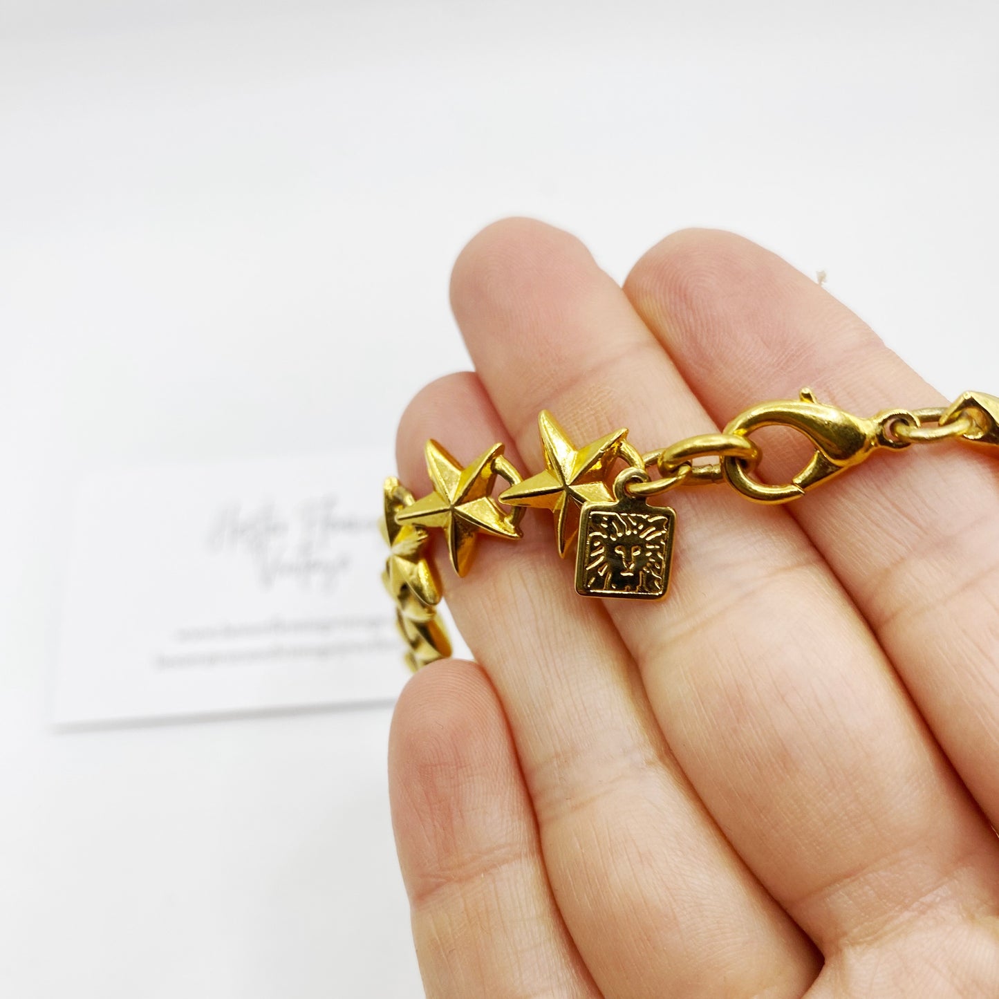 Close up of Ann Klein signature lion logo stamp.