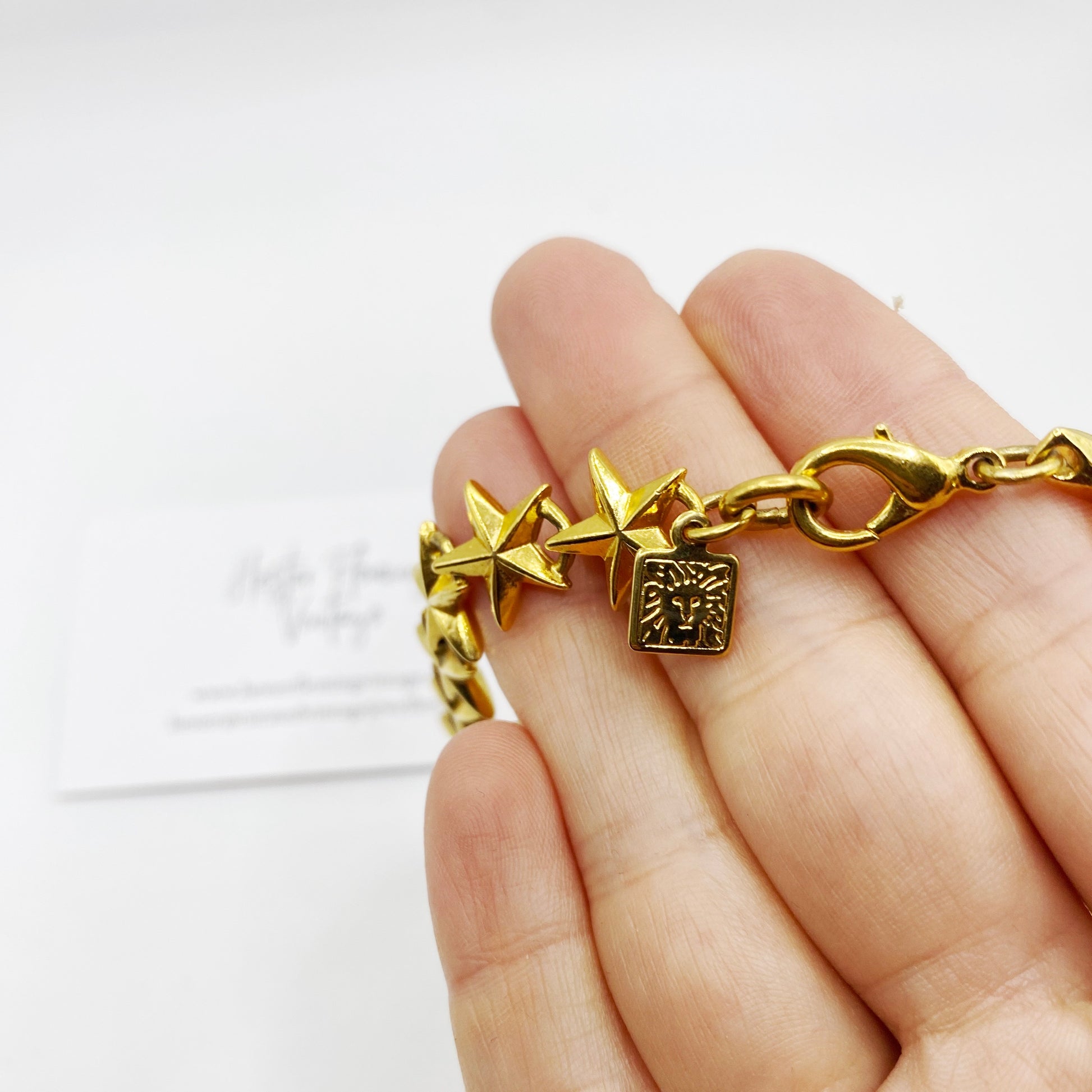 Close up of Ann Klein signature lion logo stamp.