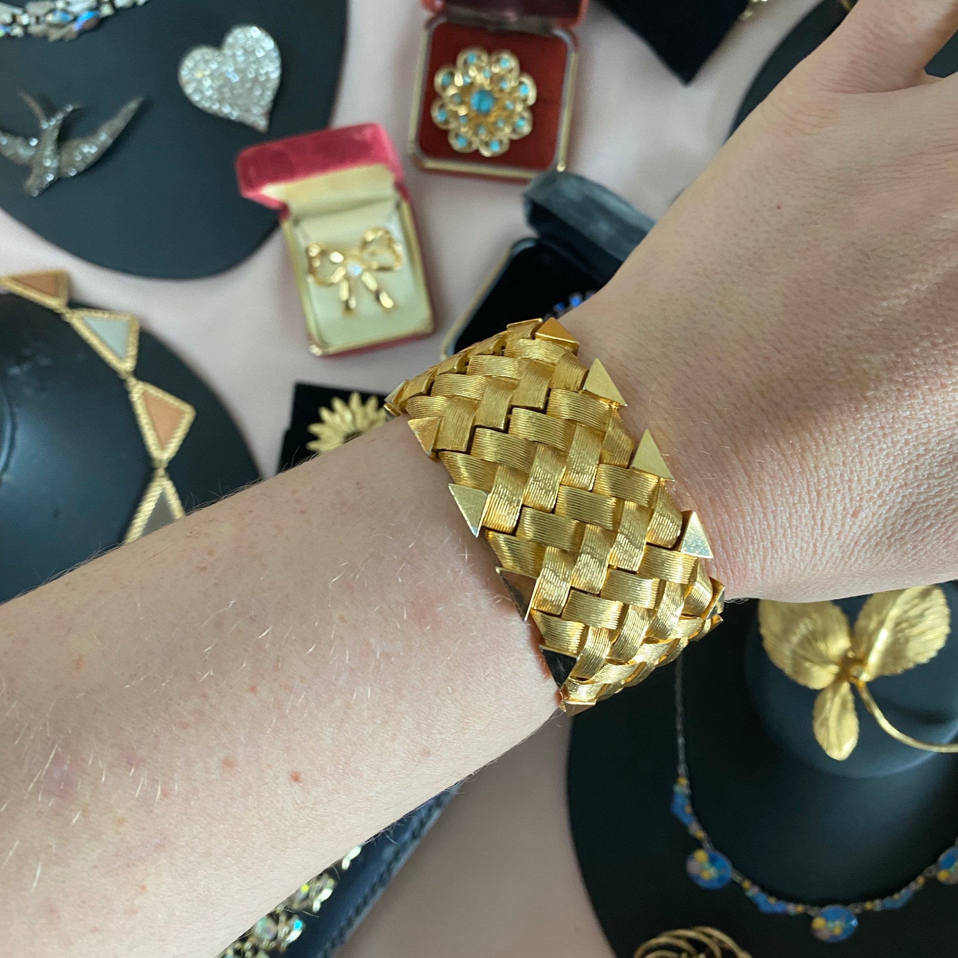 Front view of 1950s vintage Boucher gold-tone cuff bracelet with basketweave texture