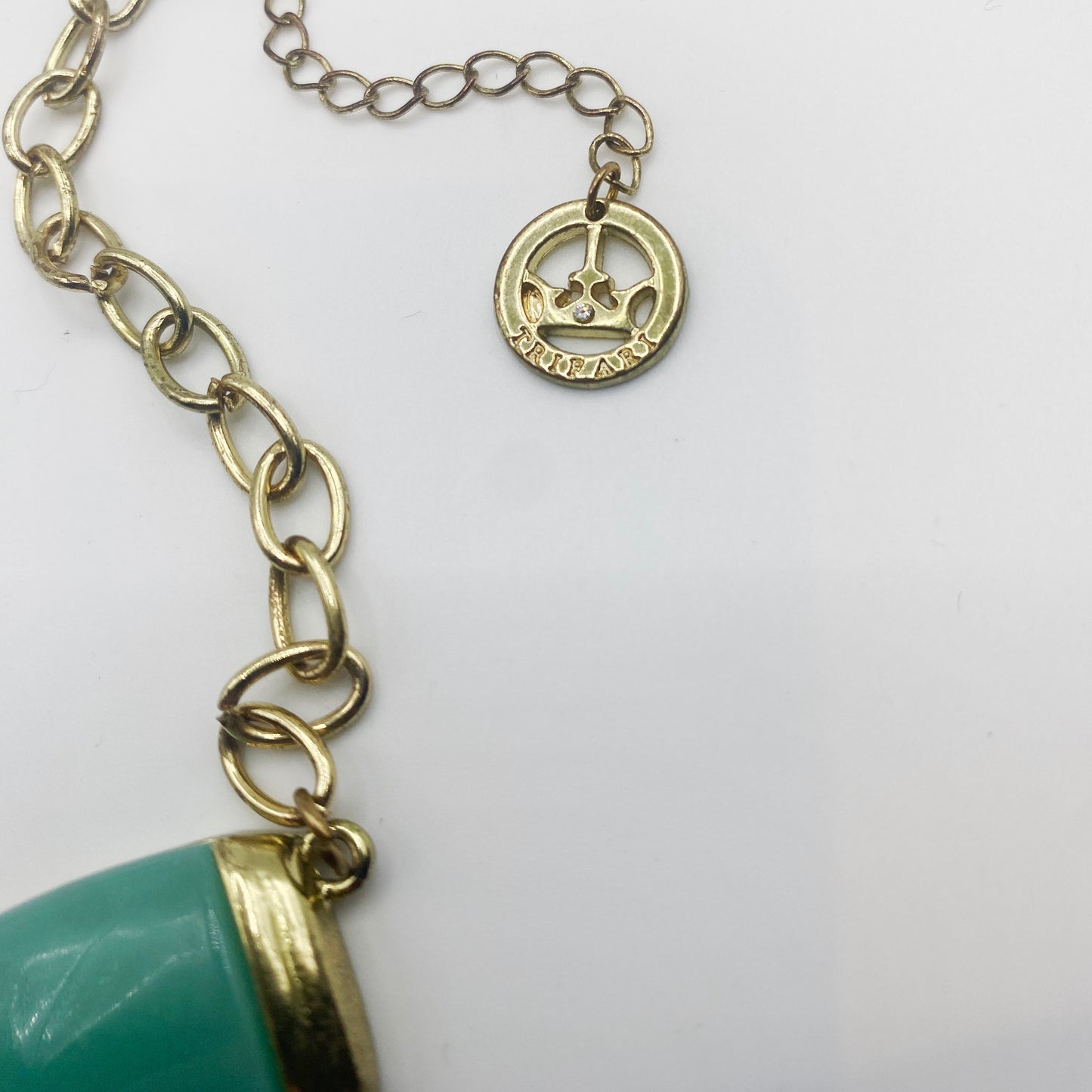 Signature Crown Trifari tag on 1980s vintage necklace, authentic designer mark.