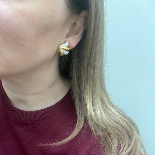 Model wearing vintage Swarovski crystal earrings styled with a classic red knit for retro glamour