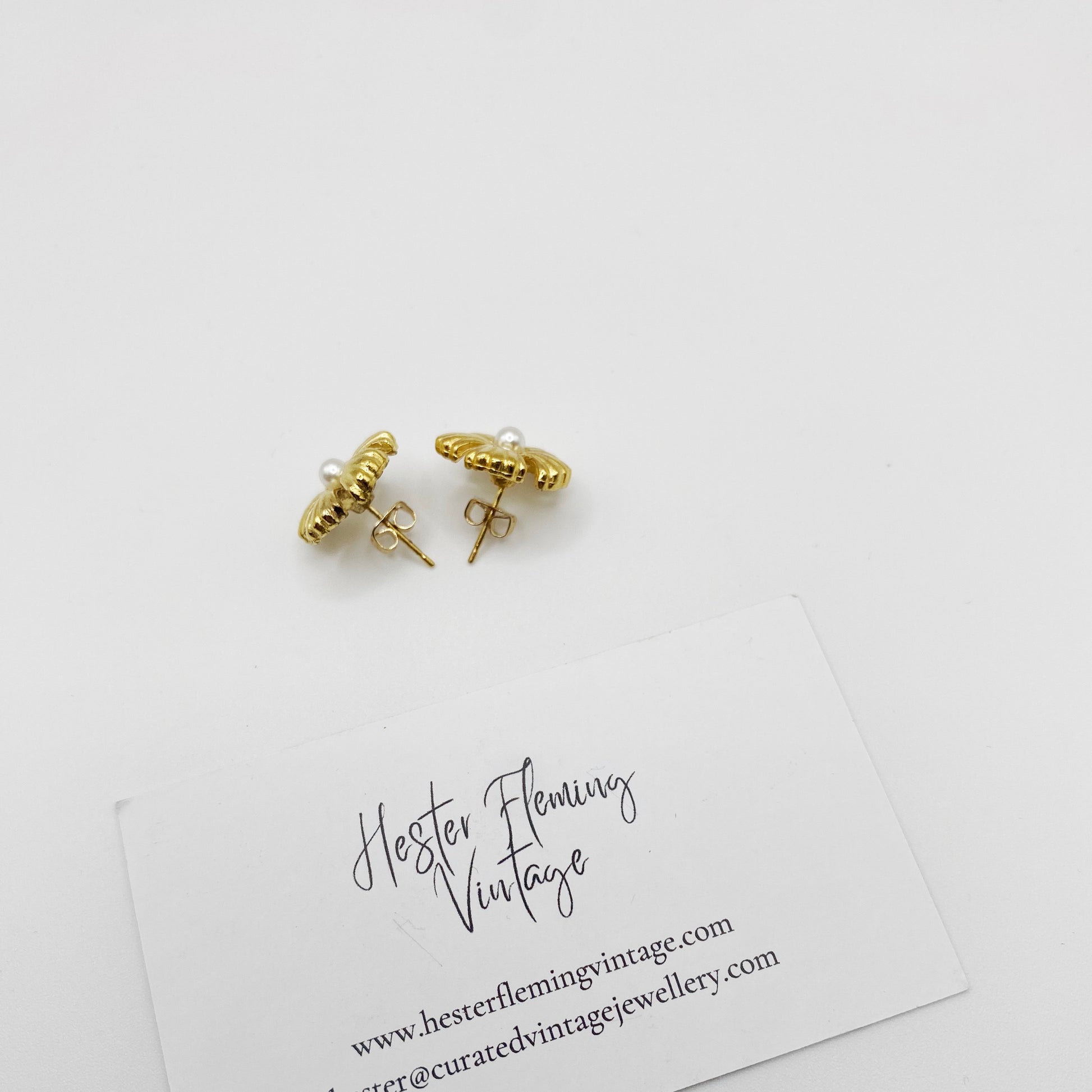 Rear view of Frayer 1990s vintage earrings showing pierced post fitting and gold-tone backing.