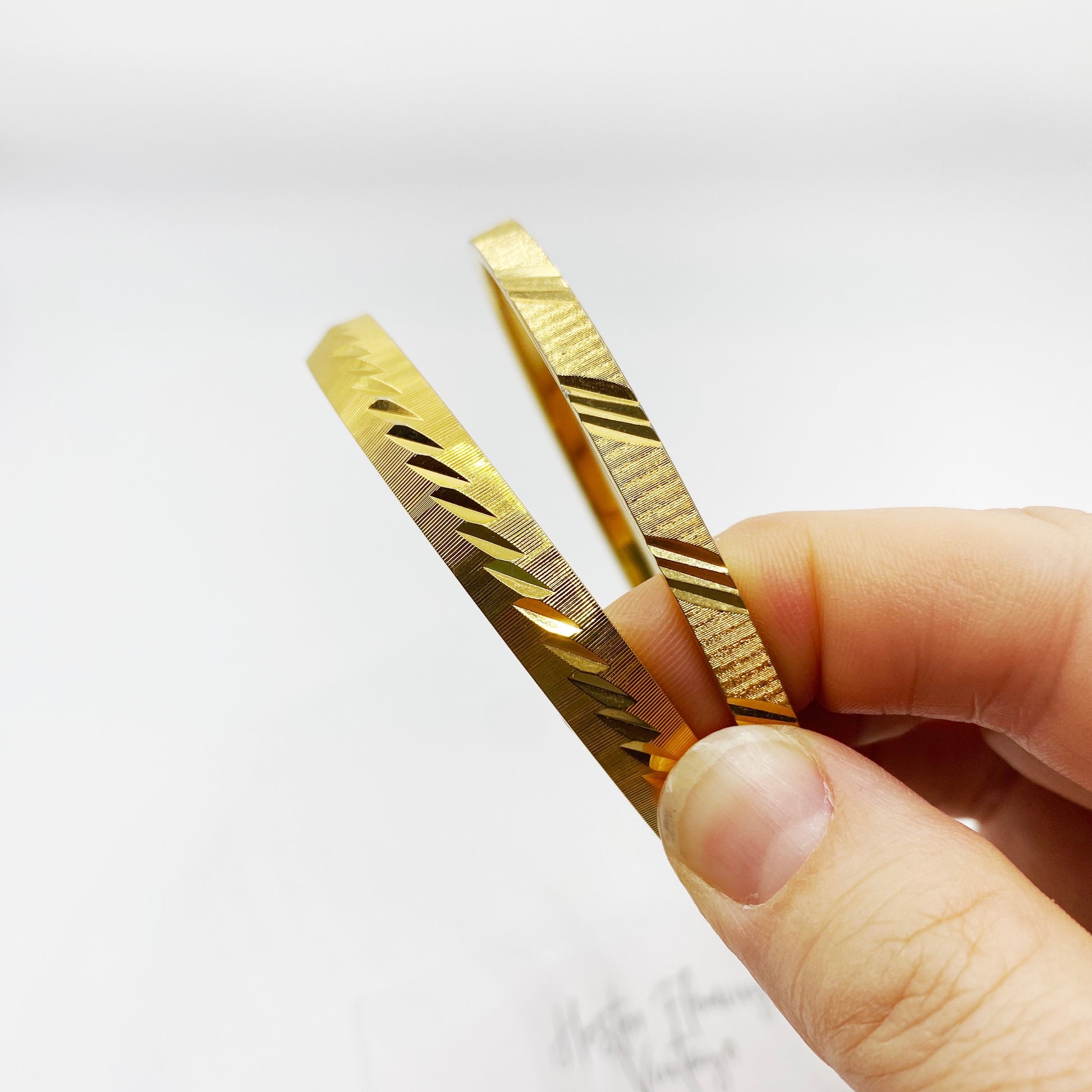 Vintage Monet bangles for medium wrist, elegant gold tone with signature craftsmanship.