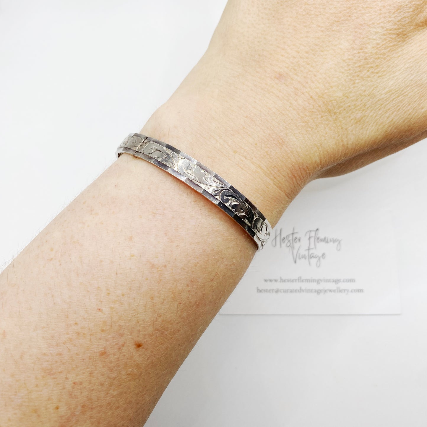 Vintage silver bangle bracelet worn on the wrist