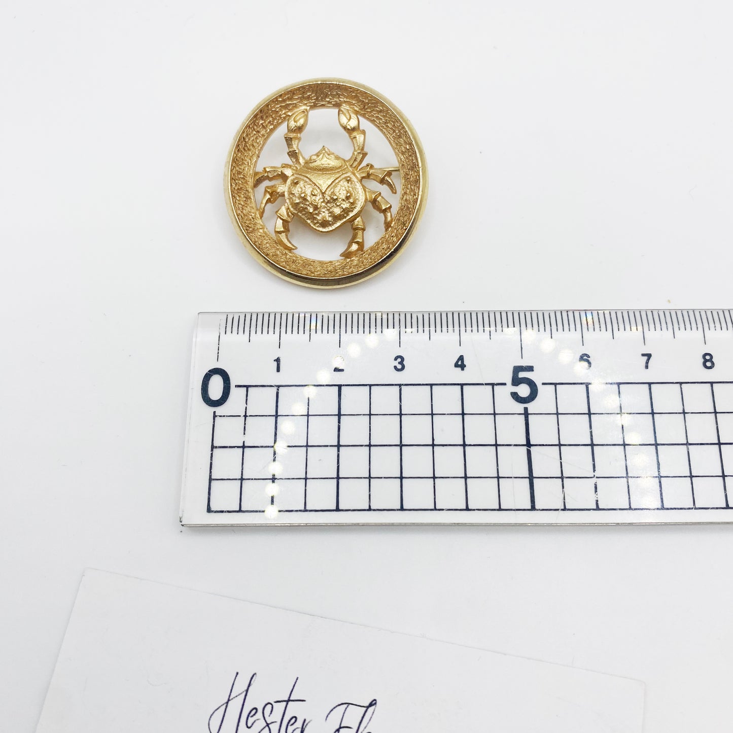 Vintage Trifari Cancer crab brooch shown next to ruler for size reference approximately 3cm diameter
