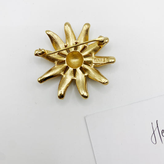 Back of vintage Trifari floral brooch showing signature